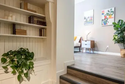a hallway with stairs and plants in a house at Castle Lofts Apartments in Montréal