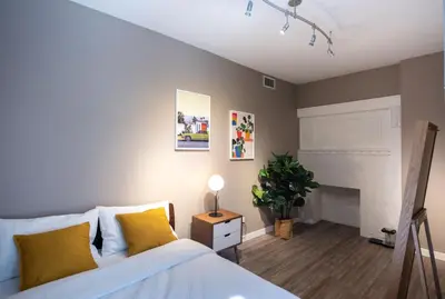 a bedroom with a bed and a fireplace at Castle Lofts Apartments in Montréal