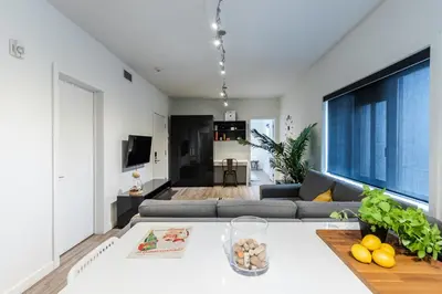 a living room with a couch and a table at Castle Lofts Apartments in Montréal