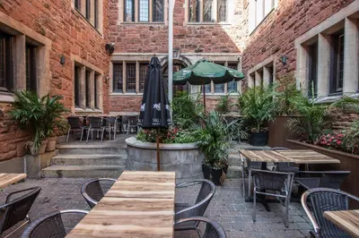 a patio with tables and chairs and an umbrella at Castle Lofts Apartments in Montréal