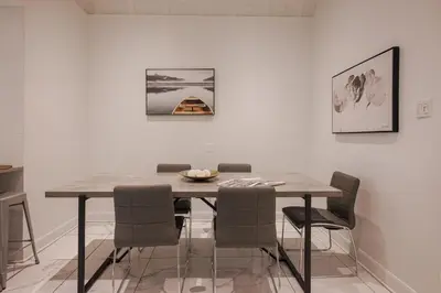 a dining room table and chairs in a room at Saint Laurent Signature Hotel Montreal in Montréal