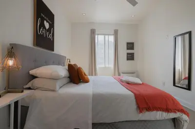 a bedroom with a large bed with pillows at Saint Laurent Signature Hotel Montreal in Montréal