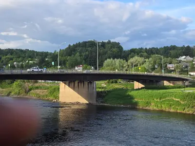 a bridge over a river with a car on it at SylverPrud in Beauceville