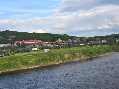 a town next to a river next to a city at SylverPrud in Beauceville