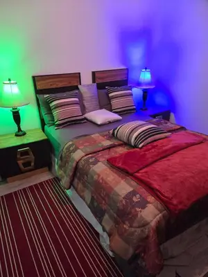 a bedroom with a large bed with two lamps at SylverPrud in Beauceville