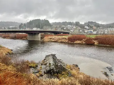 a bridge over a river with a city in the background at SylverPrud in Beauceville