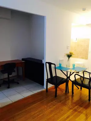 a dining room with a table and chairs and a desk at Stylish Montreal Apartment Comfortable Stay in the Golden Square Mile in Montréal