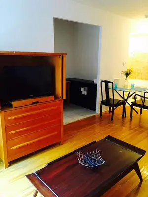 a living room with a tv and a coffee table at Stylish Montreal Apartment Comfortable Stay in the Golden Square Mile in Montréal