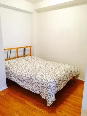 a bedroom with a bed in a room at Stylish Montreal Apartment Comfortable Stay in the Golden Square Mile in Montréal