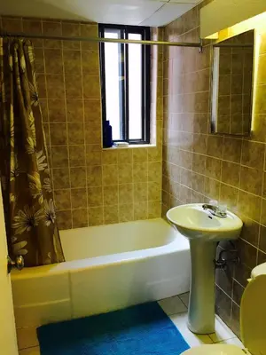a bathroom with a sink and a tub and a toilet at Stylish Montreal Apartment Comfortable Stay in the Golden Square Mile in Montréal