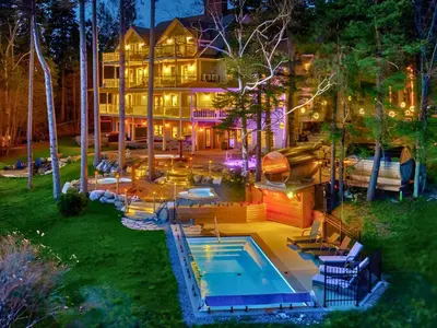 a large house with a swimming pool in front of it at Estello Suites & Spa in Lac-Mégantic