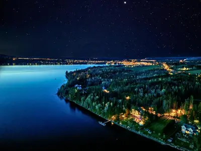 an island in the middle of the water at night at Estello Suites & Spa in Lac-Mégantic