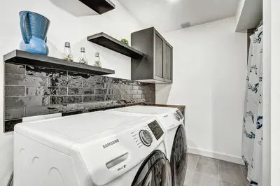 a white washer and dryer in a kitchen at Sunset Heaven - Modern Lake House with Spa in Venise-en-Québec