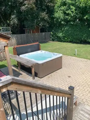 a hot tub sitting on top of a deck at Appartment with Hot Tub and Backyard and Free Parking in Saint-Hyacinthe