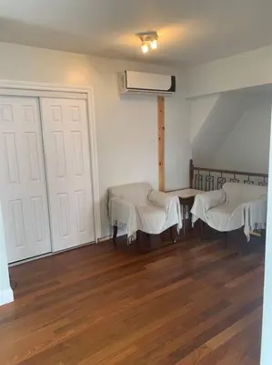 a room with two tables and white clothed chairs at Appartment with Hot Tub and Backyard and Free Parking in Saint-Hyacinthe