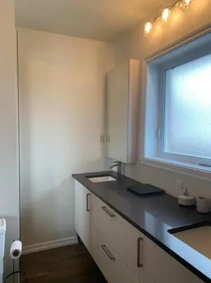 a small kitchen with a sink and a window at Appartment with Hot Tub and Backyard and Free Parking in Saint-Hyacinthe