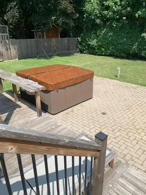 a wooden bench sitting next to a wooden table at Appartment with Hot Tub and Backyard and Free Parking in Saint-Hyacinthe