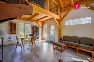 a living room with a couch and a table at L'Ermite - Rustique Écoresponsable Dans la nature in Notre-Dame-Des-Bois