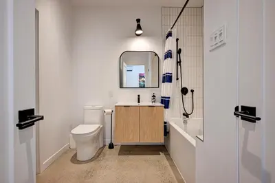 a bathroom with a toilet and a sink and a mirror at Élégant 2ch 2sdb Beau Quartier de Montréal présenté par TripMontreal IV in Montréal