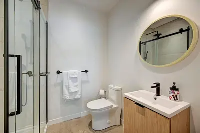 a bathroom with a toilet and a sink and a mirror at Élégant 2ch 2sdb Beau Quartier de Montréal présenté par TripMontreal IV in Montréal
