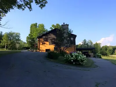 an old building with a road in front of it at Spacious luxurious Villa, bright cottage, pool, Jacuzzi, sauna, nature in Mansonville
