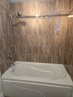 a bath tub in a bathroom with a shower at Doux cocon in Saint-Jean-sur-Richelieu
