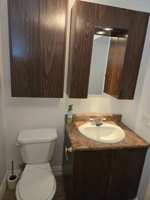 a bathroom with a toilet and a sink at Doux cocon in Saint-Jean-sur-Richelieu