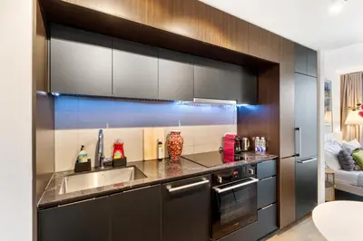 a kitchen with a sink and a stove at Luxury Apartments with View & Indoor Heated Pool in Montréal