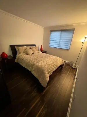 a bedroom with a bed and a window at Ste-Rose 2 bedroom apt in Laval