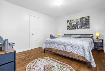 a bedroom with a bed and a rug at Amazing 3-Bedrooms in Rosemont - Montreal in Montréal