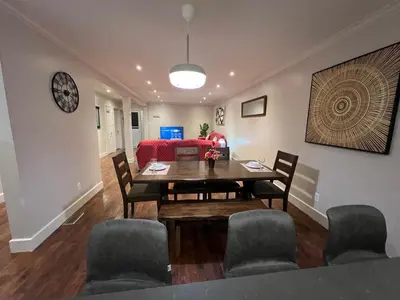 a dining room and living room with a table and chairs at Amazing 3-Bedrooms in Rosemont - Montreal in Montréal