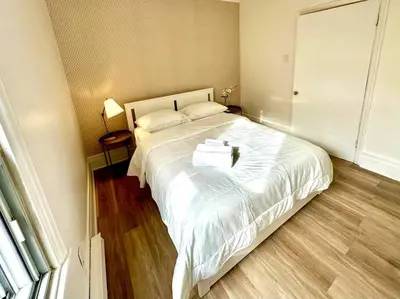 a bedroom with a large white bed in a room at 3-Bedroom Apt - Low monthly rate - Le Plateau in Montréal