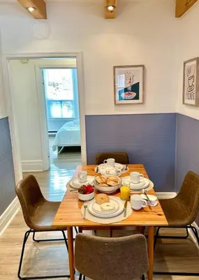 a wooden table with food on it in a room at 3-Bedroom Apt - Low monthly rate - Le Plateau in Montréal