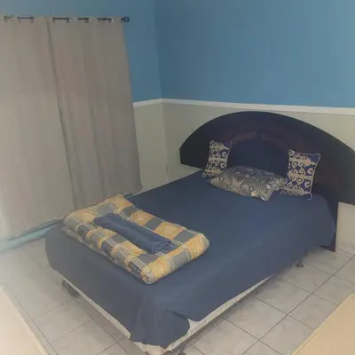 a bed with blue sheets and pillows on it at Chambre privée avec clefs intime et privée in Montréal