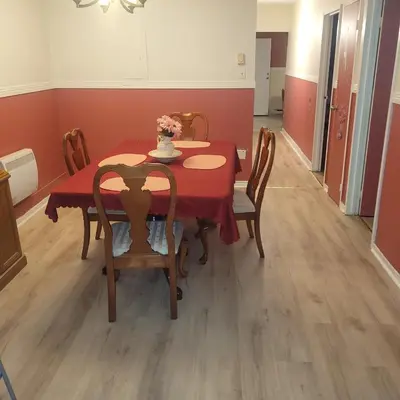 a dining room with a red table and chairs at Chambre privée avec clefs intime et privée in Montréal