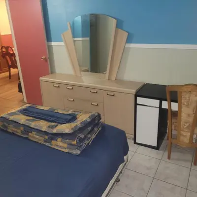 a bedroom with a dresser with a mirror on it at Chambre privée avec clefs intime et privée in Montréal