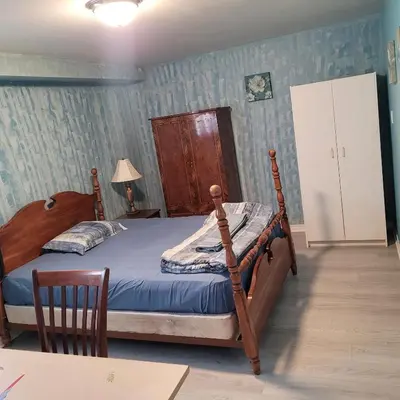 a bedroom with a bed with a wooden frame at Chambre vu à couper le souffle in Montréal