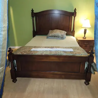 a bed in a bedroom with a wooden frame at Chambre vu à couper le souffle in Montréal