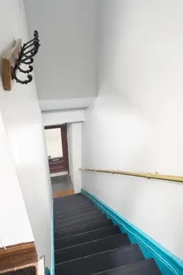 a hallway with a staircase in a building at Two bedroom duplex in Plateau Mont-Royal district in Montréal