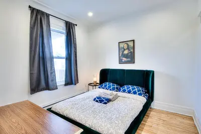 a bedroom with a bed with blue pillows on it at Montreal Vacation & Attractions Home by Downtown & Plateau in Montréal