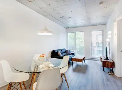 a living room with a table and a couch at Montreal rent in Montréal