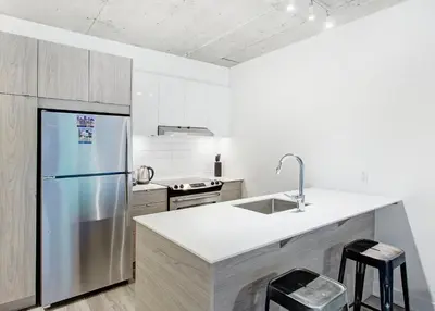 a kitchen with a stainless steel refrigerator and a sink at Montreal rent in Montréal