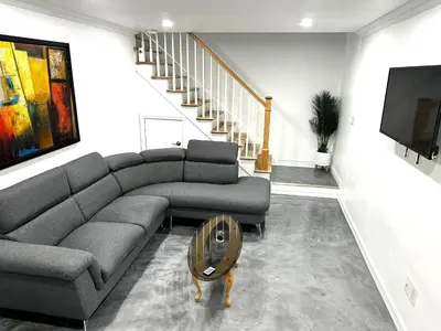 a living room with a couch and a table at Appartement en étage in Mascouche