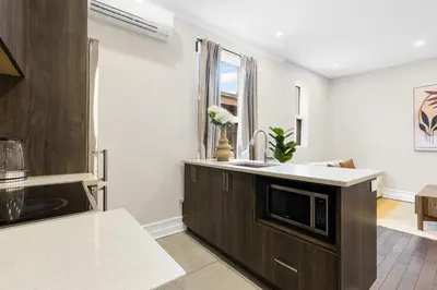 a kitchen with a sink and a microwave at The Parc Mile End ApartHotel in Montréal