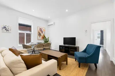 a living room with a couch and a table at The Parc Mile End ApartHotel in Montréal