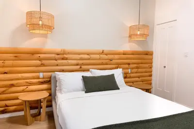 a bedroom with a white bed and two pendant lights at #1 - Luxurious 2Bds - Self Check in - Plateau - St-Denis - AC - TV in Montréal