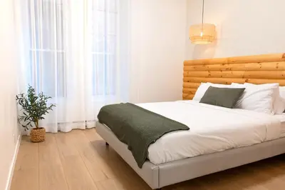 a bedroom with a white bed with a wooden headboard at #1 - Luxurious 2Bds - Self Check in - Plateau - St-Denis - AC - TV in Montréal
