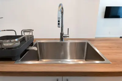 a stainless steel sink in a kitchen with a dishwasher at #1 - Luxurious 2Bds - Self Check in - Plateau - St-Denis - AC - TV in Montréal