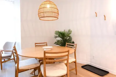 a dining room with a wooden table and chairs at #1 - Luxurious 2Bds - Self Check in - Plateau - St-Denis - AC - TV in Montréal