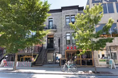 a building with a bike parked in front of it at #2 - Cozy Studio - Self Check in - Plateau - St-Denis - AC - TV in Montréal